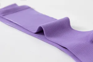 Detalle de primer plano de la manga de compresión acanalada violeta, tejido elástico.
