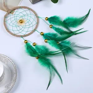 Detailed view of handmade green feather dream catcher, perfect indoor hanging decor gift.