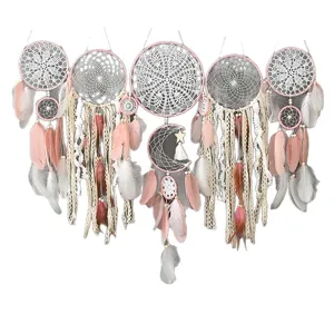 Handmade pink dream catcher wall hanging with feathers and lace for home wedding decor.