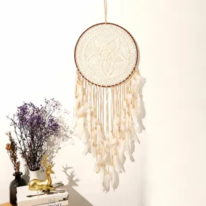 Bohemian feather dream catcher wall hanging detail featuring woven web and wooden beads.