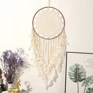 Large handmade bohemian dream catcher wall hanging with white feathers and delicate crochet net.