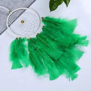 Handmade bohemian green feather dream catcher hanging ornament for bedroom wall decor.