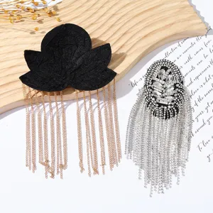 Detailed view of fringe epaulets with rhinestones and metal chains, DIY clothing accessory.
