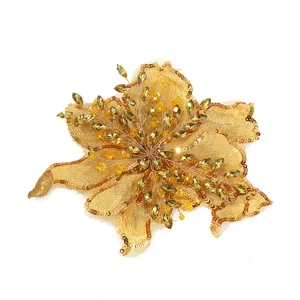 Detailed close-up of a luxurious gold floral embroidered patch with shimmering sequins and beads.