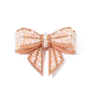 Pearl rhinestone bow shoe clip detail, sparkling wedding footwear decorative accessory piece.
