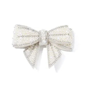 Pearl rhinestone bow shoe clip accessory detail close up shiny wedding footwear decor