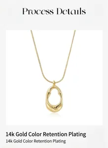 Close-up detail of minimalist gold pendant necklace with smooth irregular hollow oval design.