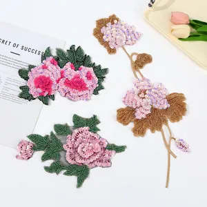 Detailed close-up of handmade sequin flower clothing patches, intricate beading and floral appliques.