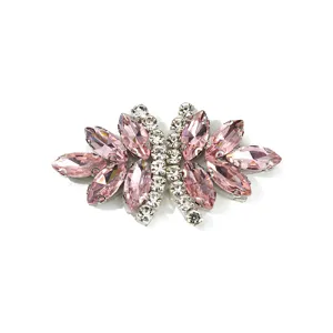 Pink crystal rhinestone bow apparel accessory close-up showing glittering marquise gems.