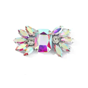 Close-up of sparkling multicolored glass rhinestone shoe buckle and DIY garment accessory detail.