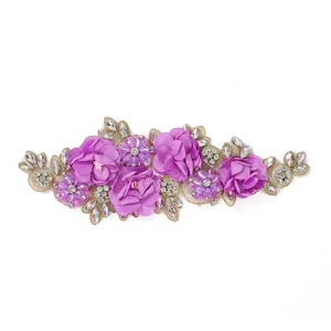 Exquisite purple 3D flower embroidery applique with rhinestones and gold thread details.