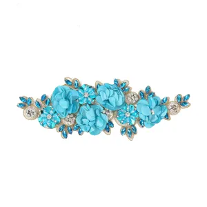 Detail view of 3D blue flower embroidered lace patch for bridal dress and apparel decoration.