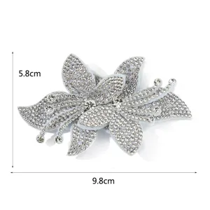 Close-up detail of the glittering crystal rhinestone orchid patch showing sparkling texture.