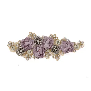 Detailed close-up of 3D purple chiffon flower patch for wedding dress decoration.