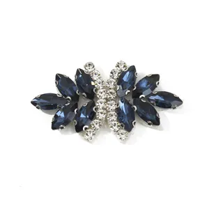 Close-up detail view of the elegant bow-shaped rhinestone apparel patch with sparkling blue crystals.