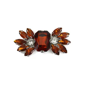 Detailed view of sparkling amber and clear glass rhinestone shoe buckle and DIY apparel accessory.