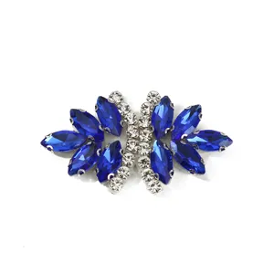 Close-up detail shot of sparkling blue and clear crystal rhinestone bow clothing accessory patch.