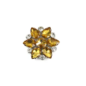 Crystal rhinestone flower detail, sparkling yellow and clear stones set in silver metal.