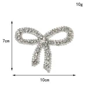 Close-up detail of sparkling rhinestone bow patch, perfect for DIY wedding dress and apparel.