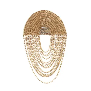 Rhinestone fringe shoulder epaulet close-up, gold metal chain decorative patch for DIY garments and evening dress.