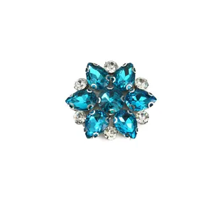Close-up shot showing the sparkling crystal details of the blue rhinestone flower shoe buckle.