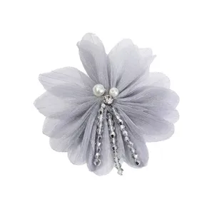Closeup detail of gray sheer fabric flower brooch with pearls and crystal bead tassels.