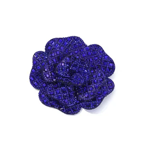 Closeup of dark blue rhinestone camellia flower patch, sparkling 3d DIY fashion accessory.
