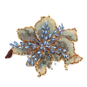 Gorgeous floral embroidered patch featuring sparkling blue crystals and gold sequins for apparel.