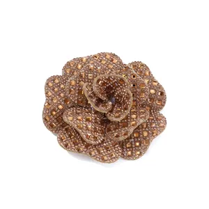 Close-up detail of a stunning brown rhinestone camellia flower patch, sparkling crystal accessory.
