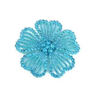 Detailed close-up of sparkling turquoise rhinestone flower, brilliant crystal diamante charm.