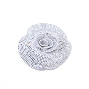 Close-up detail view of a shimmering rhinestone camellia flower for DIY apparel decoration.