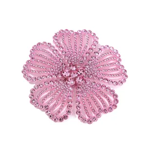 Close-up detail of sparkling pink rhinestone flower accessory, brilliant crystal craftsmanship.