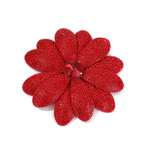 Close-up of red rhinestone flower patch, sparkling crystal center detail for DIY shoes.