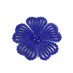 Blue rhinestone flower detail close-up, sparkling crystal craftsmanship for custom apparel decor.
