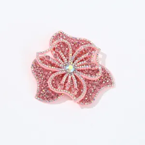 Exquisite pink rhinestone flower patch with sparkling crystal details for DIY clothing decor.