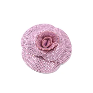 Pink rhinestone camellia flower brooch accessory, sparkly crystal floral DIY clothing charm.