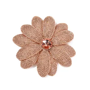 Close-up detail of the sparkling rhinestone flower patch accessory, shiny crystal center.