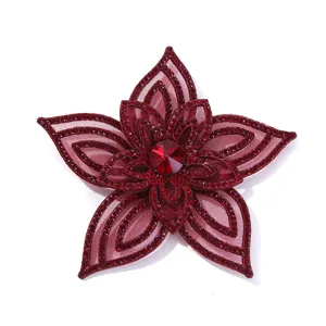 Close-up of wine red rhinestone flower applique detail, sparkling crystals on layered mesh.