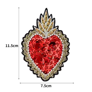 Detailed view of handmade red sequin sacred heart embroidered patch DIY garment accessory.