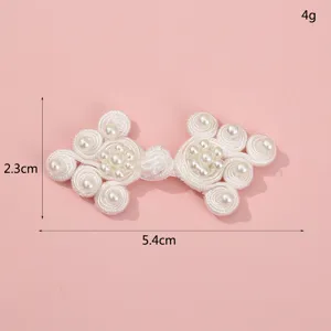 Detailed shot of white Chinese traditional handmade frog button with faux pearls, 5.4x2.3cm.