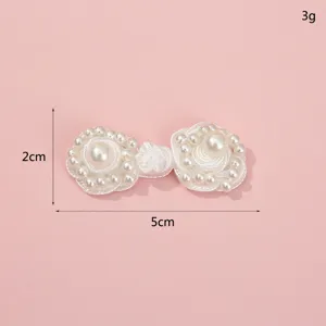 Handcrafted pearl Chinese frog button, traditional clothing accessory, white fabric knot.