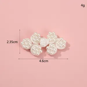 Handmade pearl Chinese frog button detail shot, white beaded clothing accessory for cheongsam.