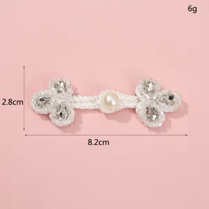 Detail shot of handmade pearl rhinestone Chinese knot button, decorative clothing accessory.
