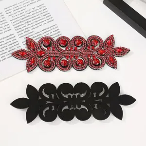 Detailed view of DIY red rhinestone crystal patch appliques with black felt backing for qipao decor.