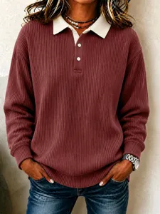 Close-up view of a stylish ribbed long-sleeve polo top featuring a contrast white collar.
