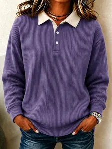 Detailed view of the purple ribbed knit long-sleeve top featuring a white contrast polo collar.