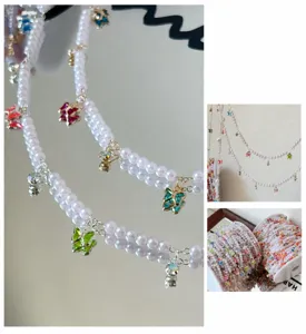 Close-up detail of DIY pearl chain trim with colorful crystal butterfly charms for costume decor.