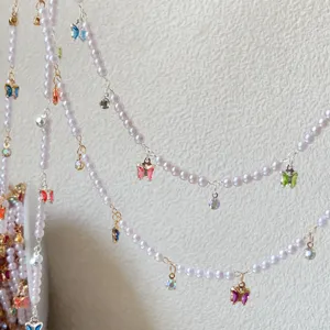 DIY pearl chain with colorful crystal butterfly charms for Hanfu Lolita fashion craft.