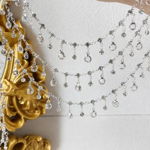 Close-up detail of multi-layer rhinestone fringe chain, sparkling glass crystal DIY trim.