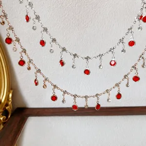 DIY rhinestone tassel chain with red glass stones and prong setting for handmade jewelry.